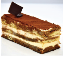 A piece of cake with a piece of chocolate on top