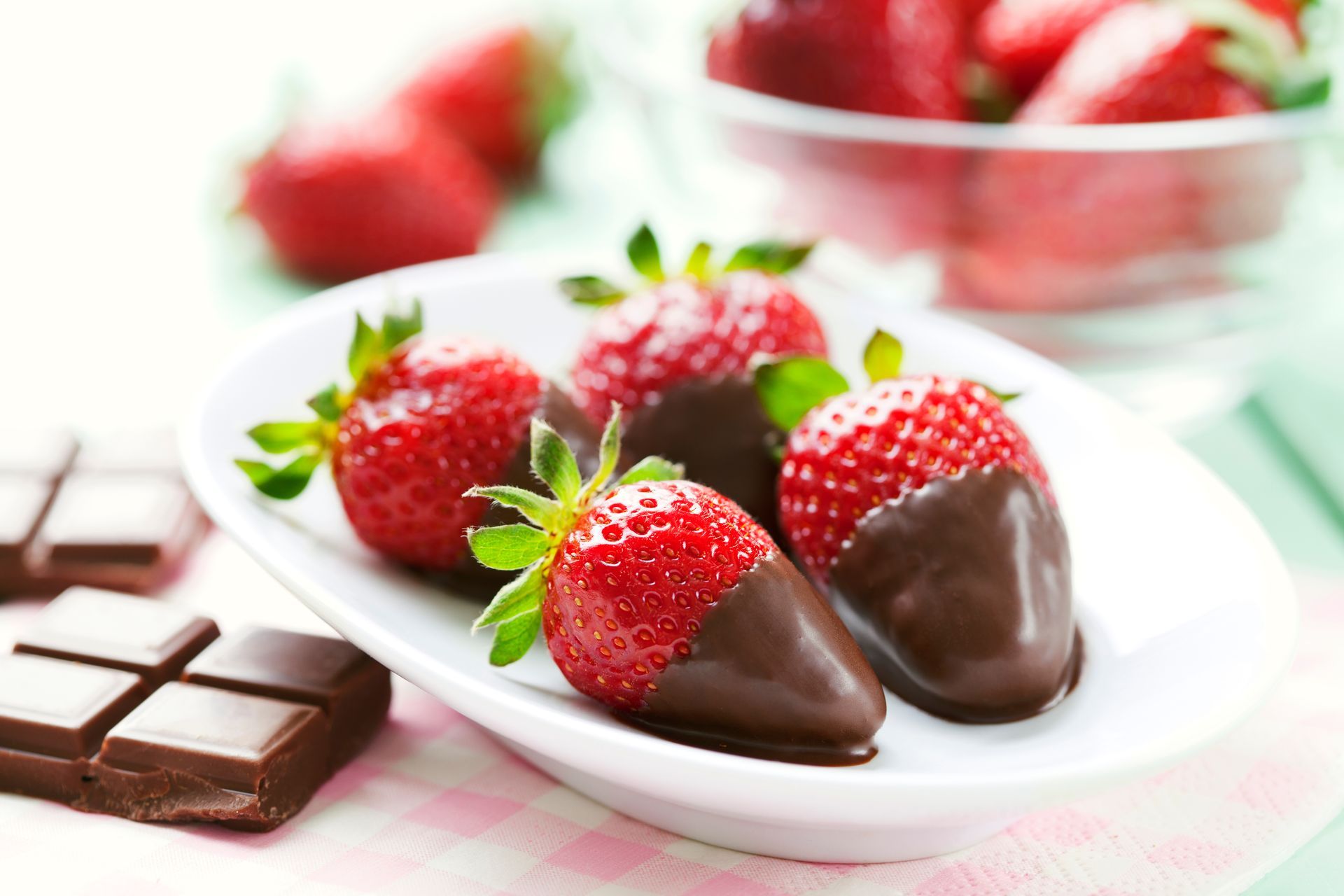 Strawberries dipped in chocolate on a white plate