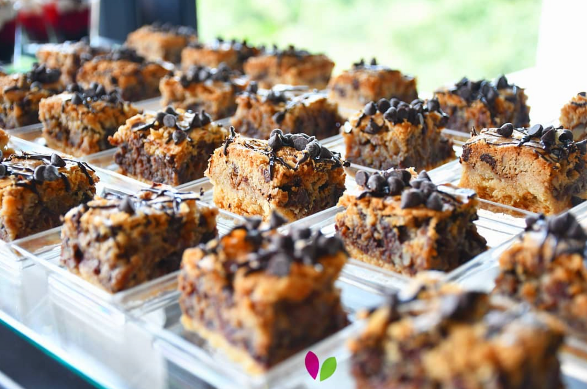 A bunch of brownies are sitting on a tray on a table.