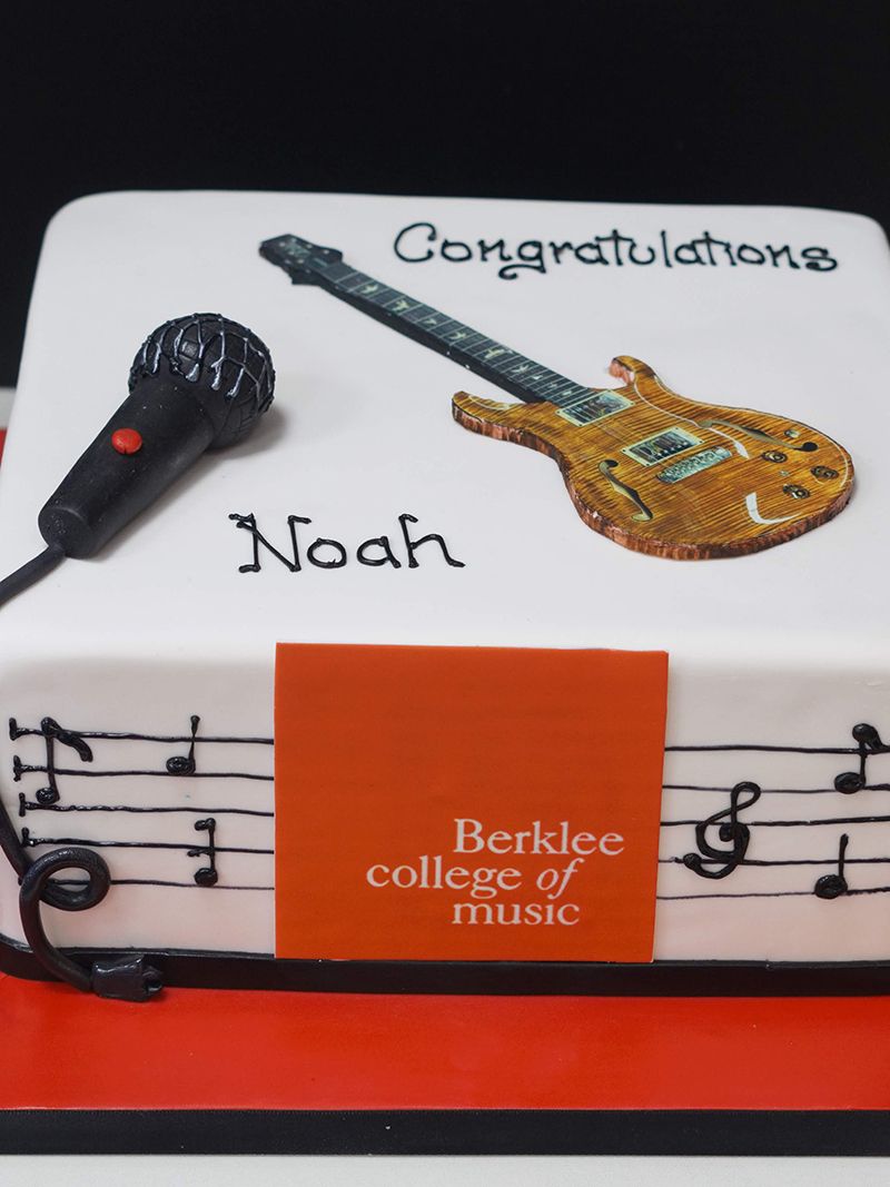 A cake with a guitar and a microphone on it
