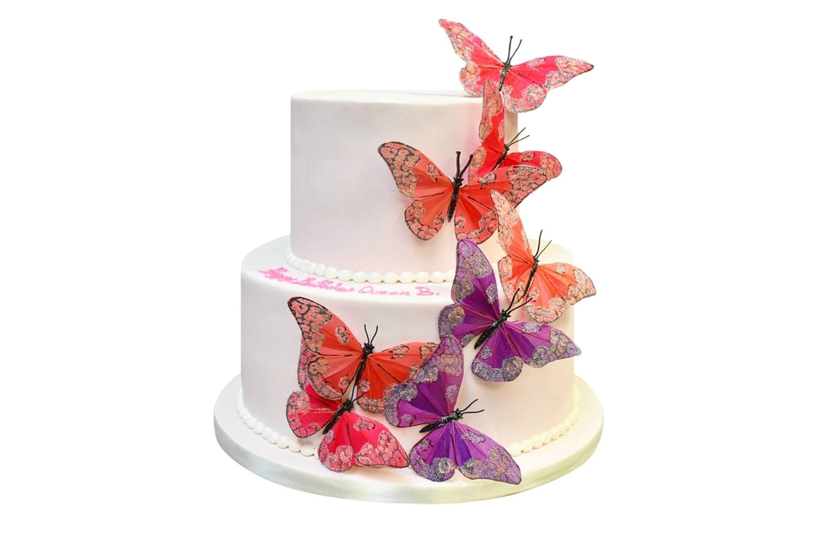 A white cake with pink and purple butterflies on it.