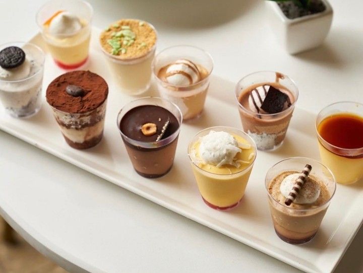 A white plate topped with a variety of desserts on a table.