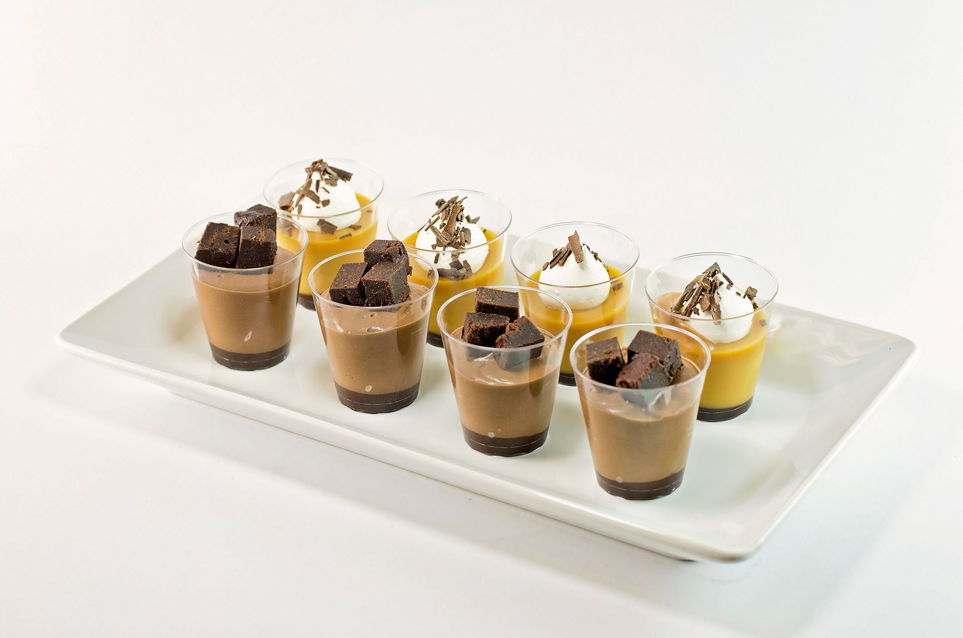 A white plate topped with a variety of desserts.