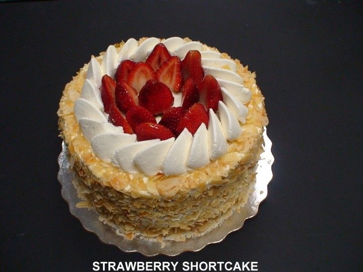 A strawberry shortcake with whipped cream and strawberries on top