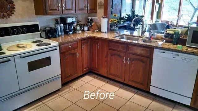 A before picture of a kitchen with wooden cabinets and white appliances.