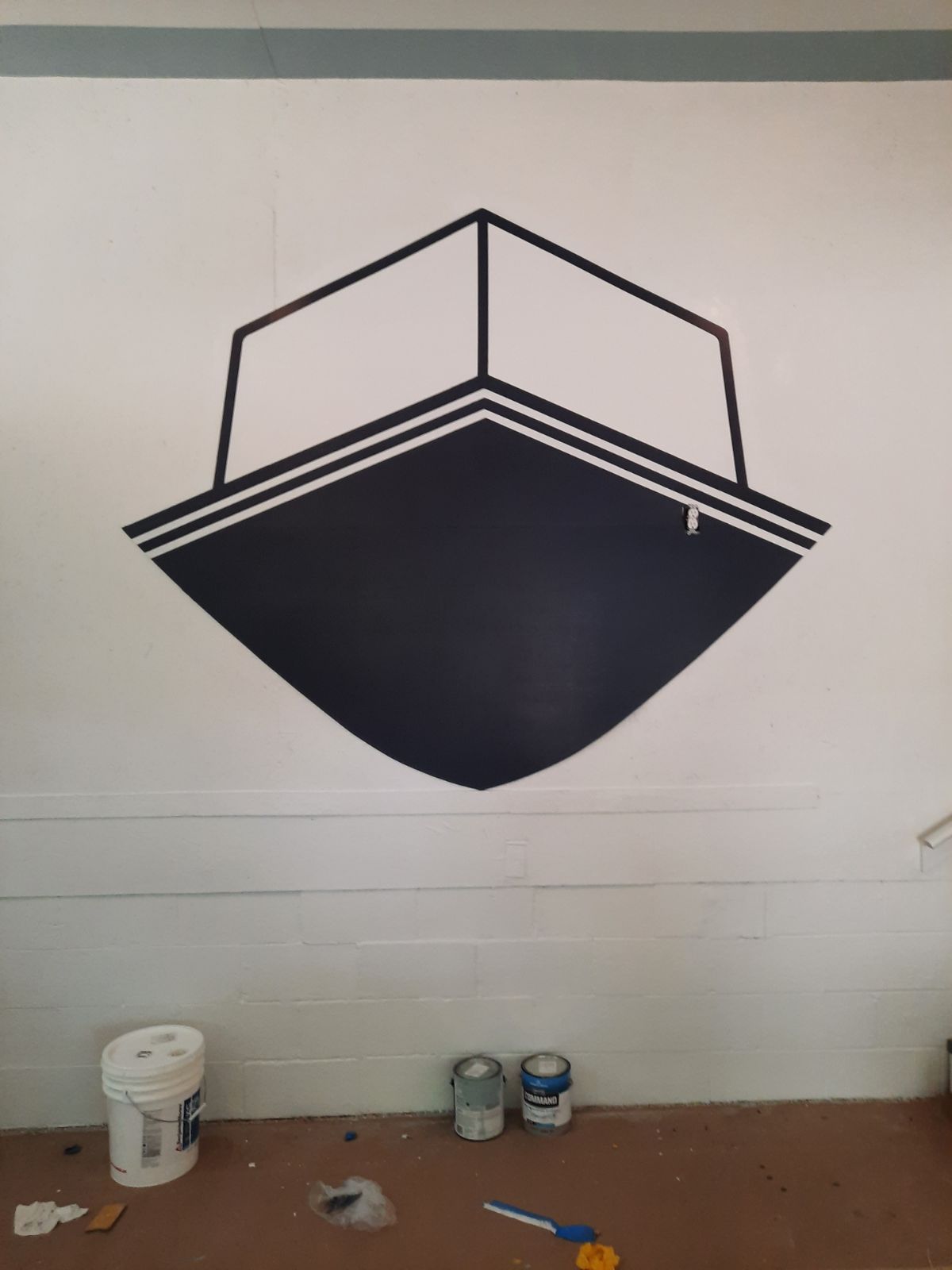 A wall with a drawing of a boat on it