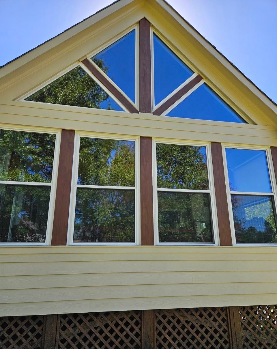 A house with a triangle shaped roof and a lot of windows