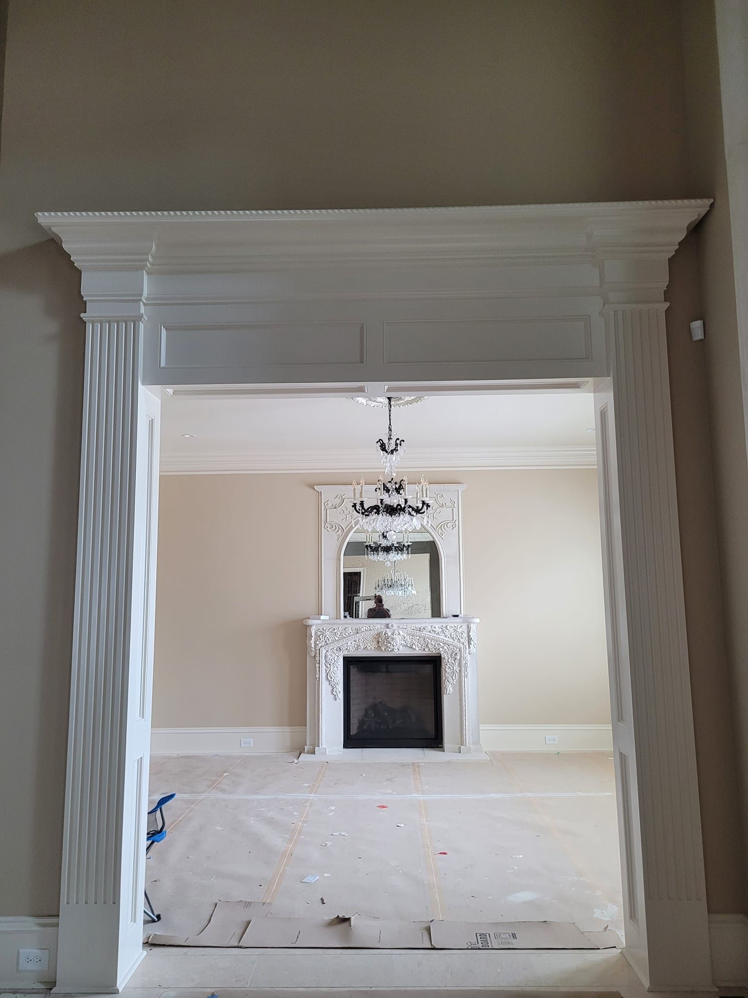 A living room with a fireplace and a mirror