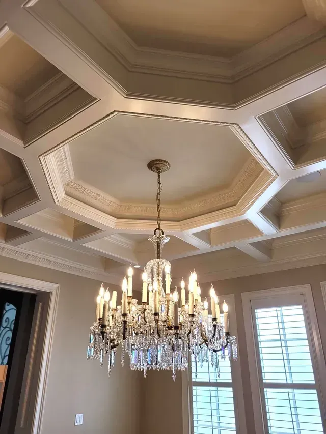 A large chandelier is hanging from the ceiling of a room.