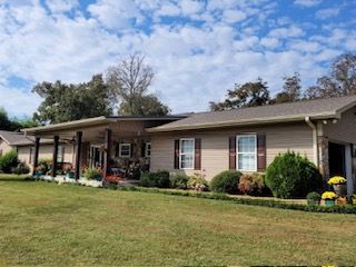 A large house with a large lawn in front of it.