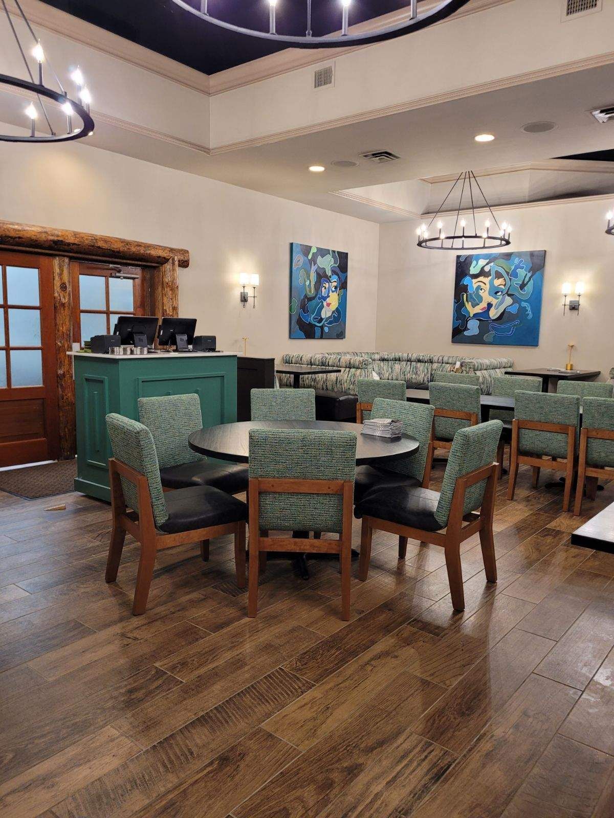 A restaurant with tables and chairs in a large room.