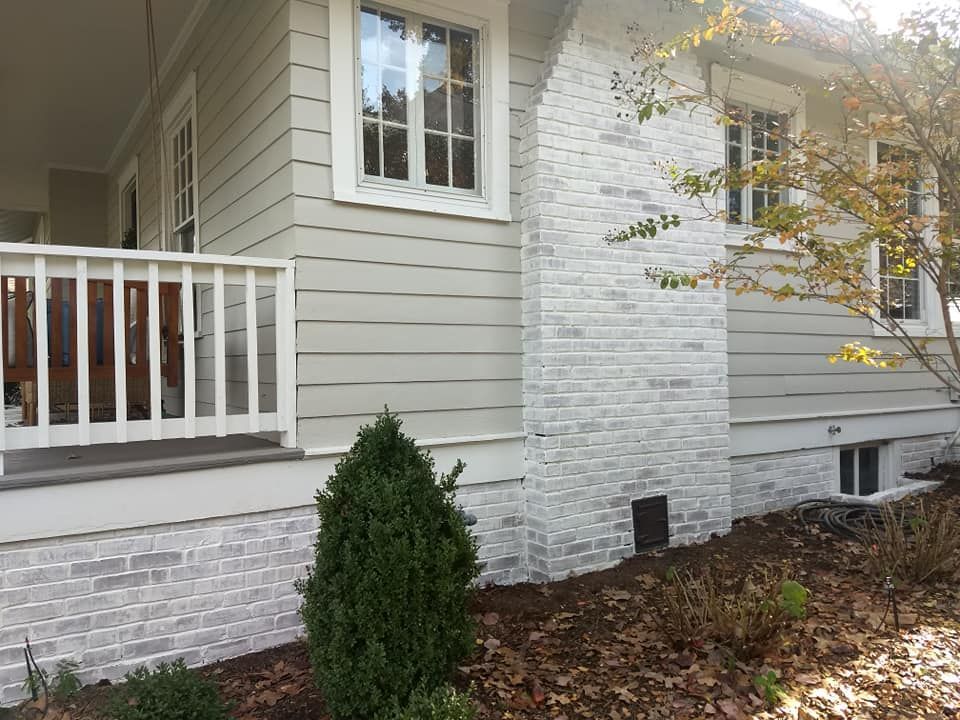 A white house with a porch and a white railing