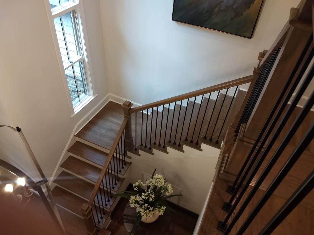 An aerial view of a wooden staircase in a house.