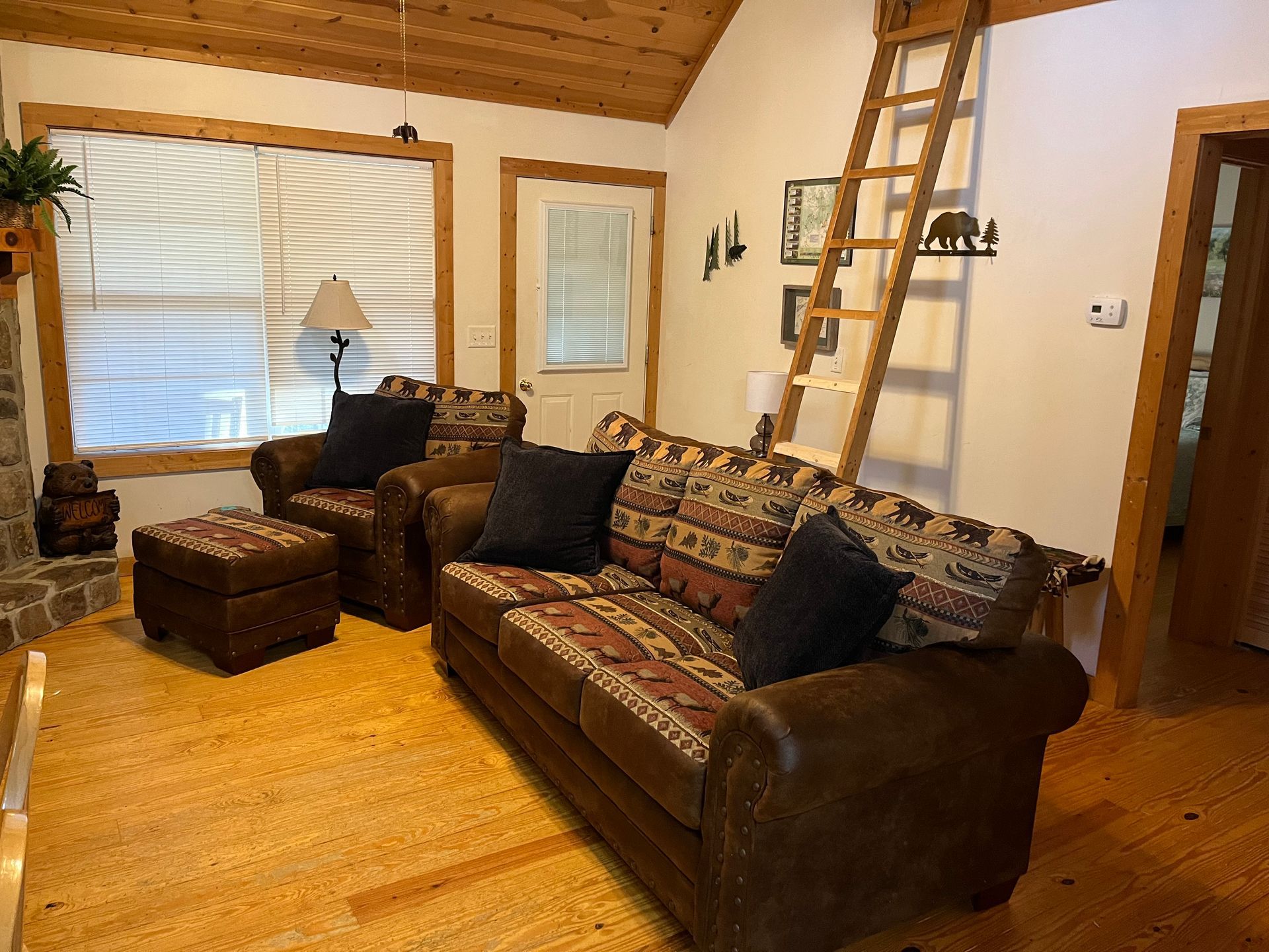 A living room with a couch , chair , coffee table and rug.