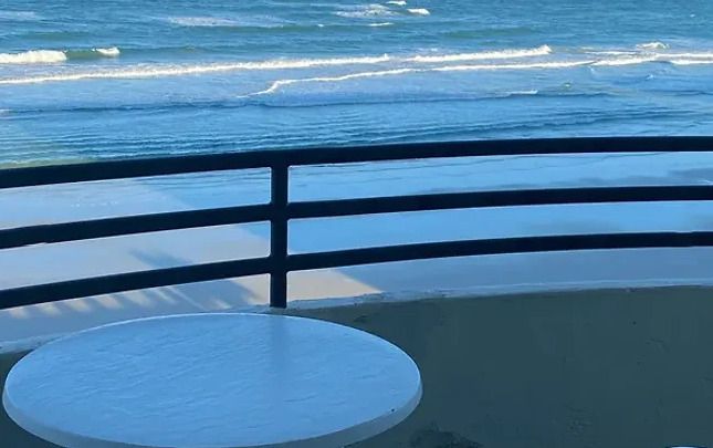 A table on a balcony overlooking the ocean