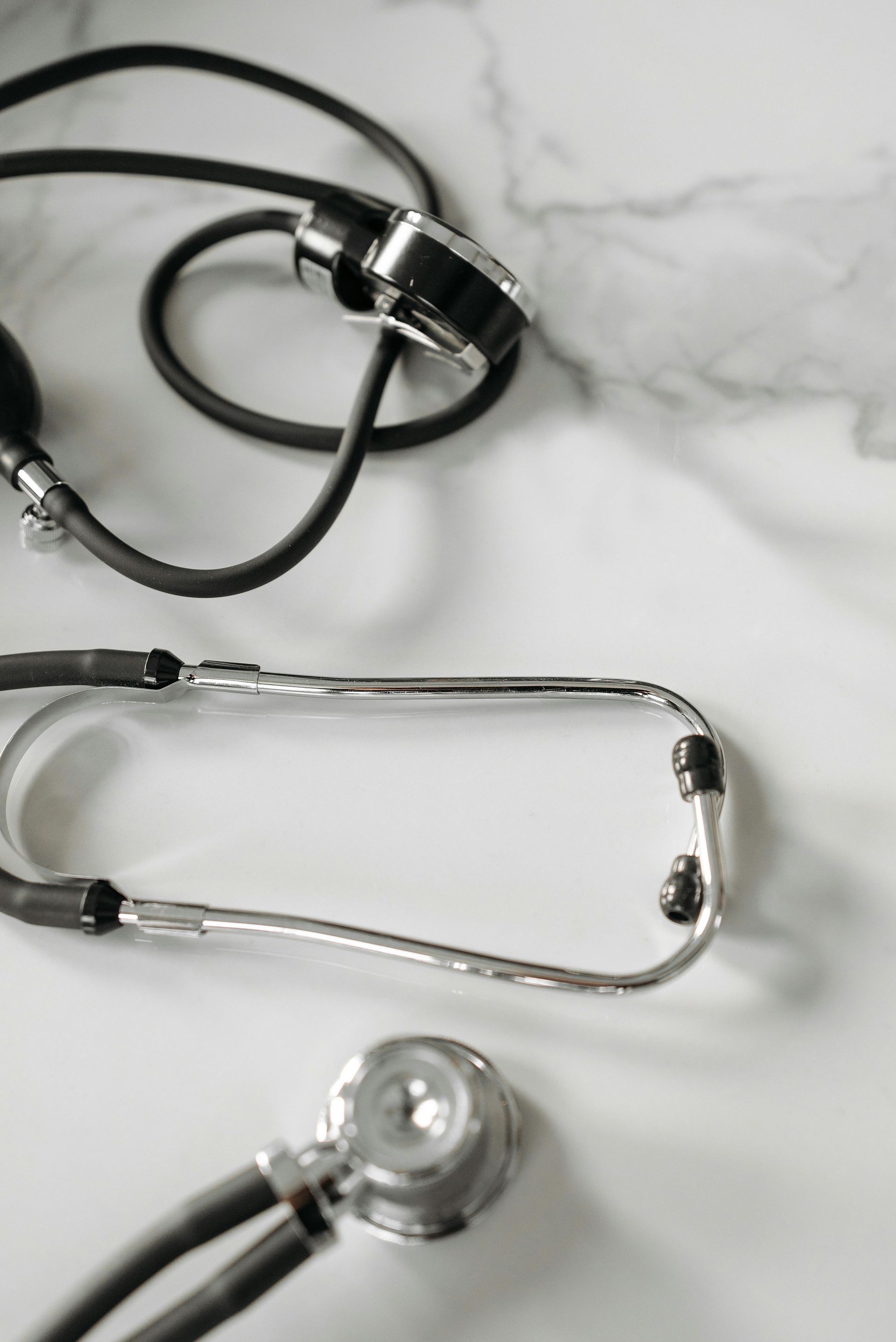 Stethoscopes on a white marble surface
