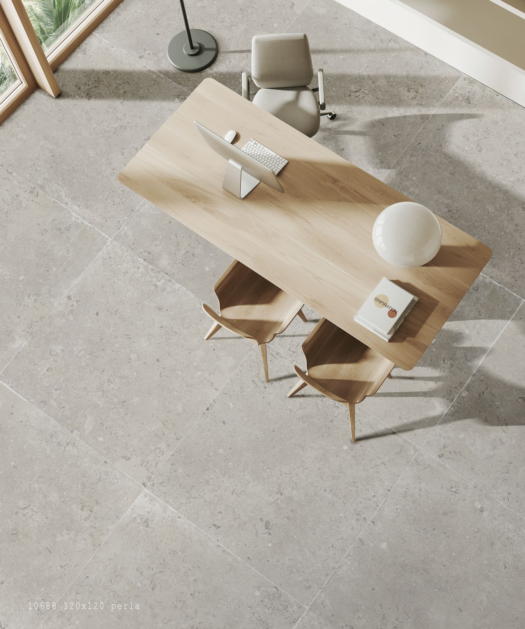 Un espacio moderno visto desde arriba: mesa de madera clara con laptop y lámpara, rodeada de sillas que resaltan sobre la elegancia de la losa Coralina.