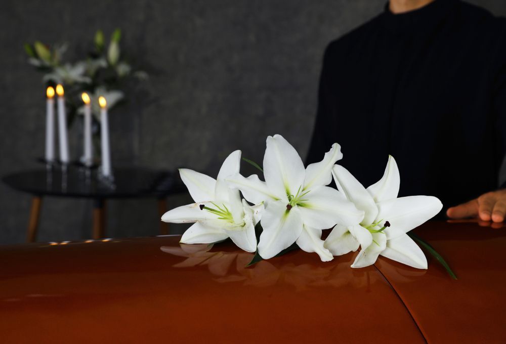  Young Man Near Casket With White Lilies In Funeral Home —  A Better Way Funerals in Chatswood, NSW