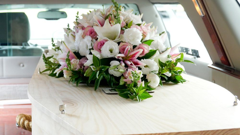 Funeral Casket, Coffin Burial With Flowers —  A Better Way Funerals in Chatswood, NSW