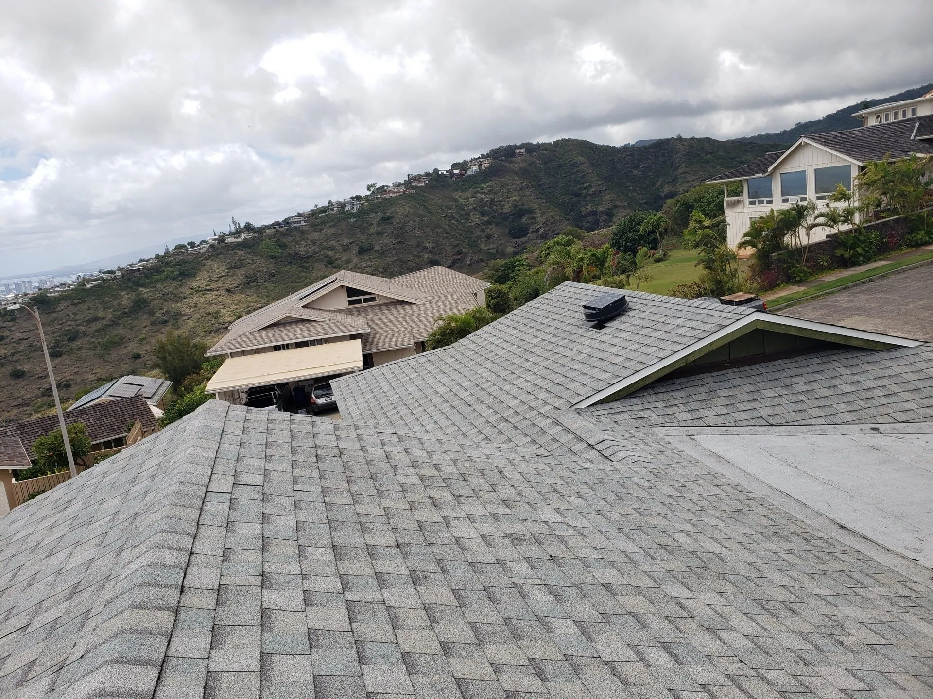 A house with a roof that has been damaged by a storm.