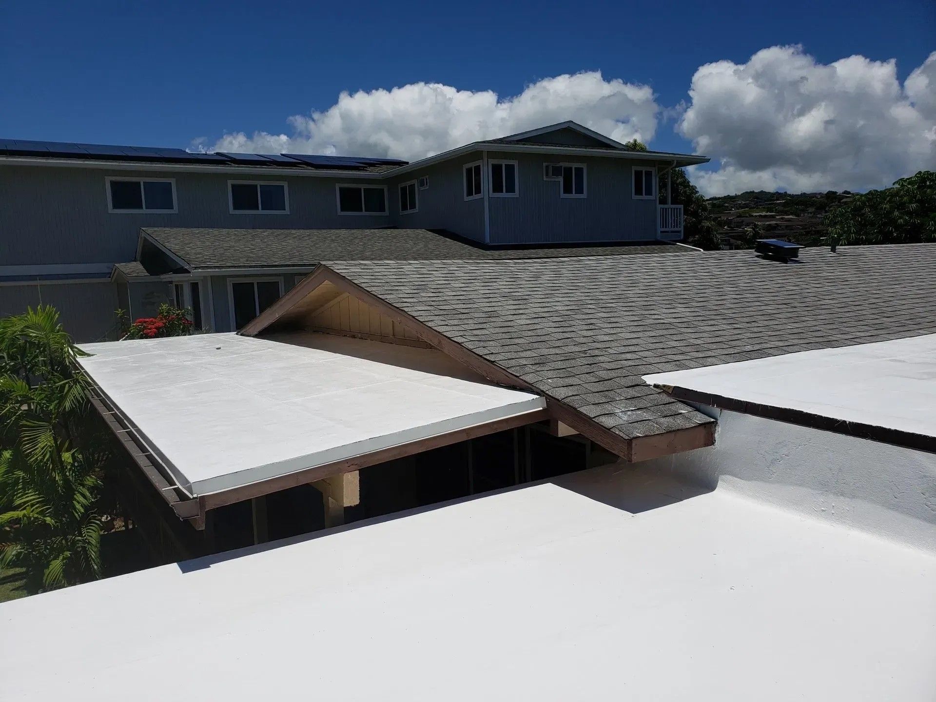A house with a white roof and a gray roof.