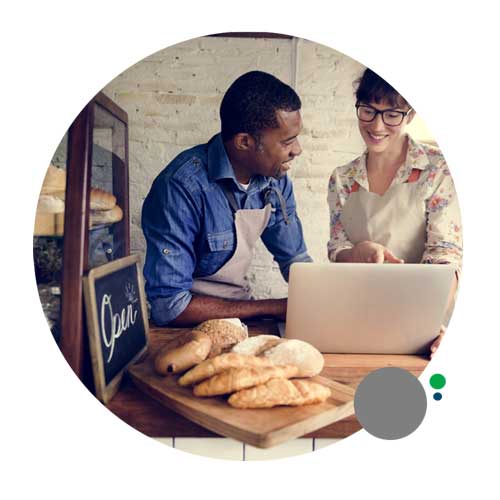 young business owners looking at computer