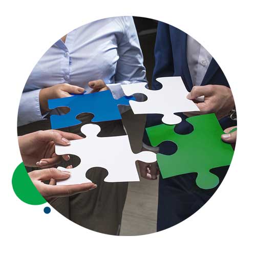 four people putting puzzle pieces together