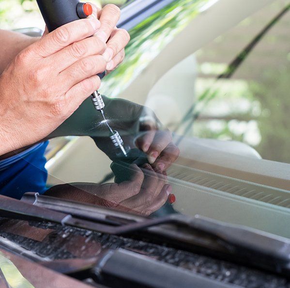 Man Fixing the Auto Crack — Hunstville, AL — A+ Glass Company LLC