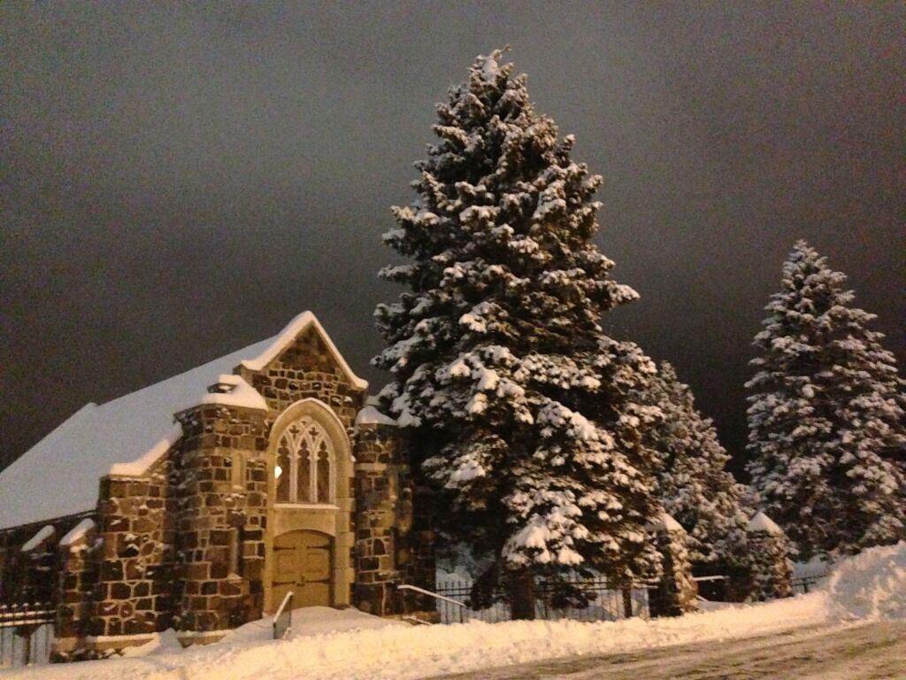 An artist 's impression of a hotel lobby with a couch , chairs , and plants.