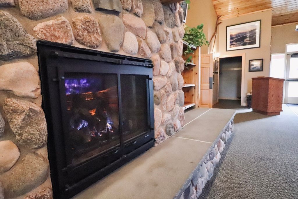 An artist 's impression of a hotel lobby with a couch , chairs , and plants.