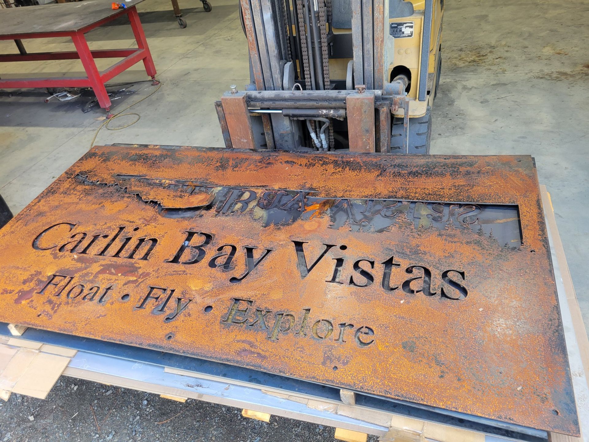 Rusty metal sign with cutout lettering 