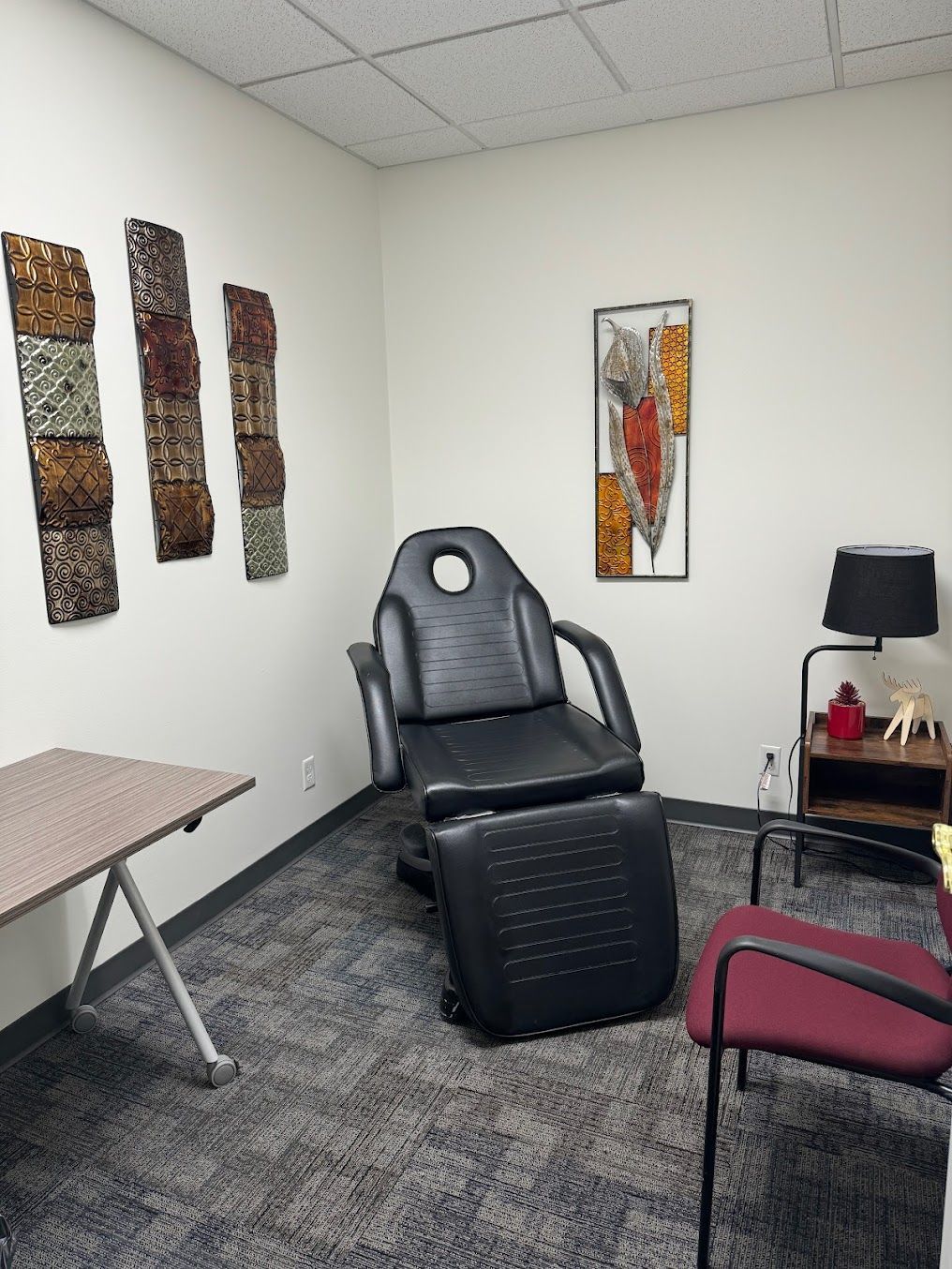 A room with a chair and a table in it