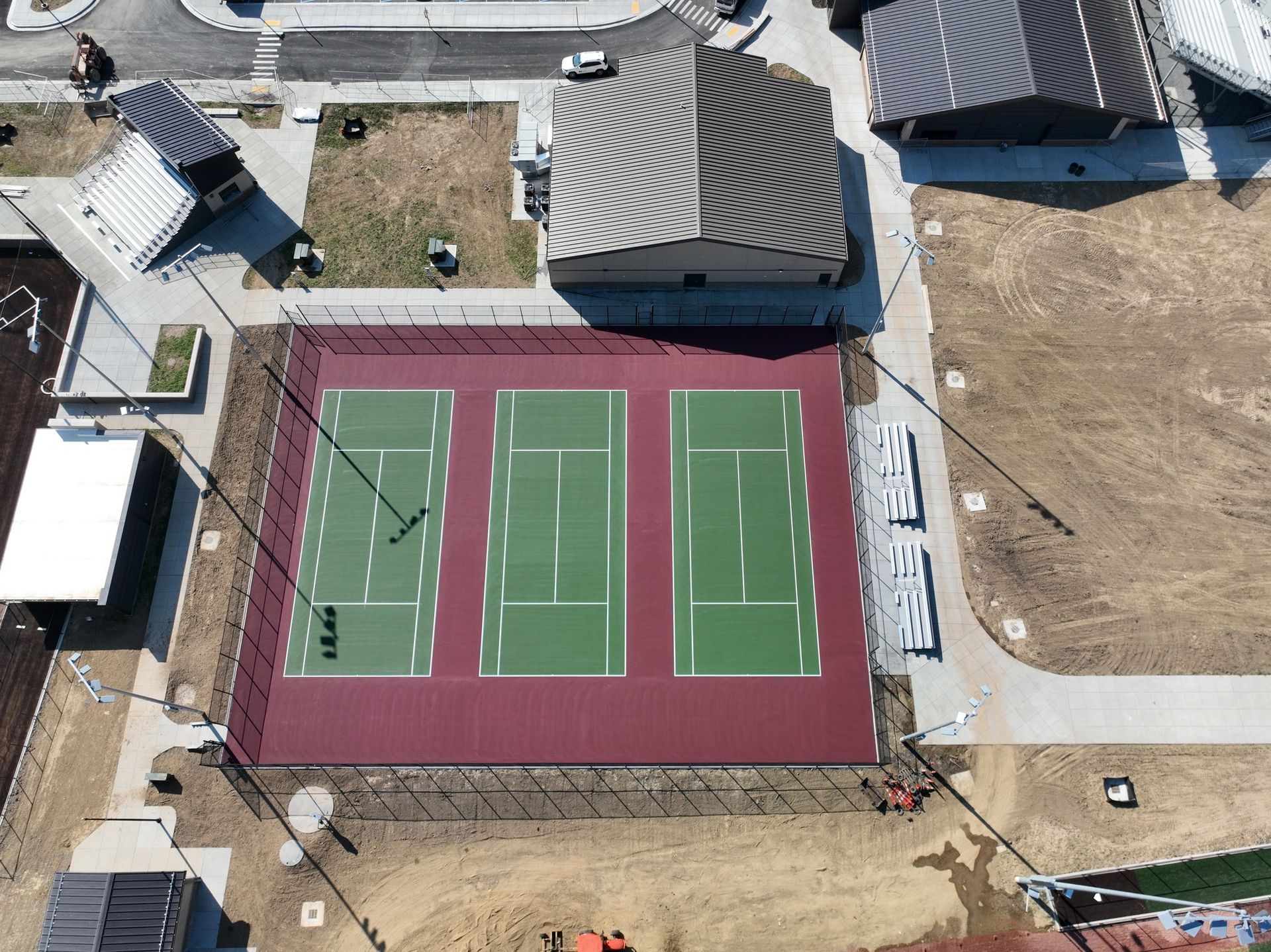 An aerial view of a tennis court surrounded by buildings