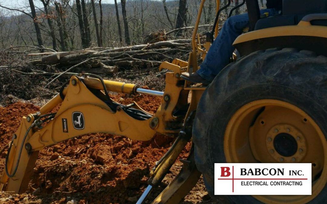 A yellow tractor is being used by babcon inc.