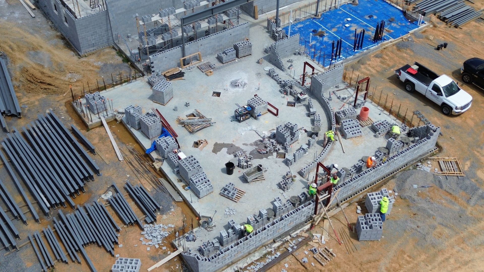 An aerial view of a construction site with a truck parked in front of it.