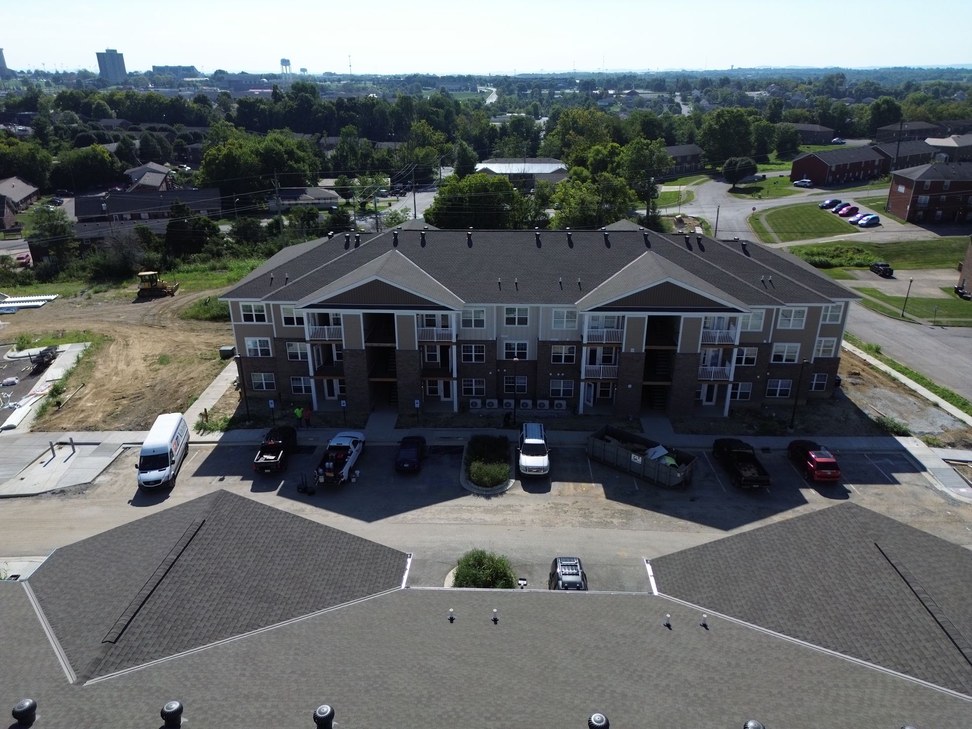 An aerial view of a building with cars parked in front of it