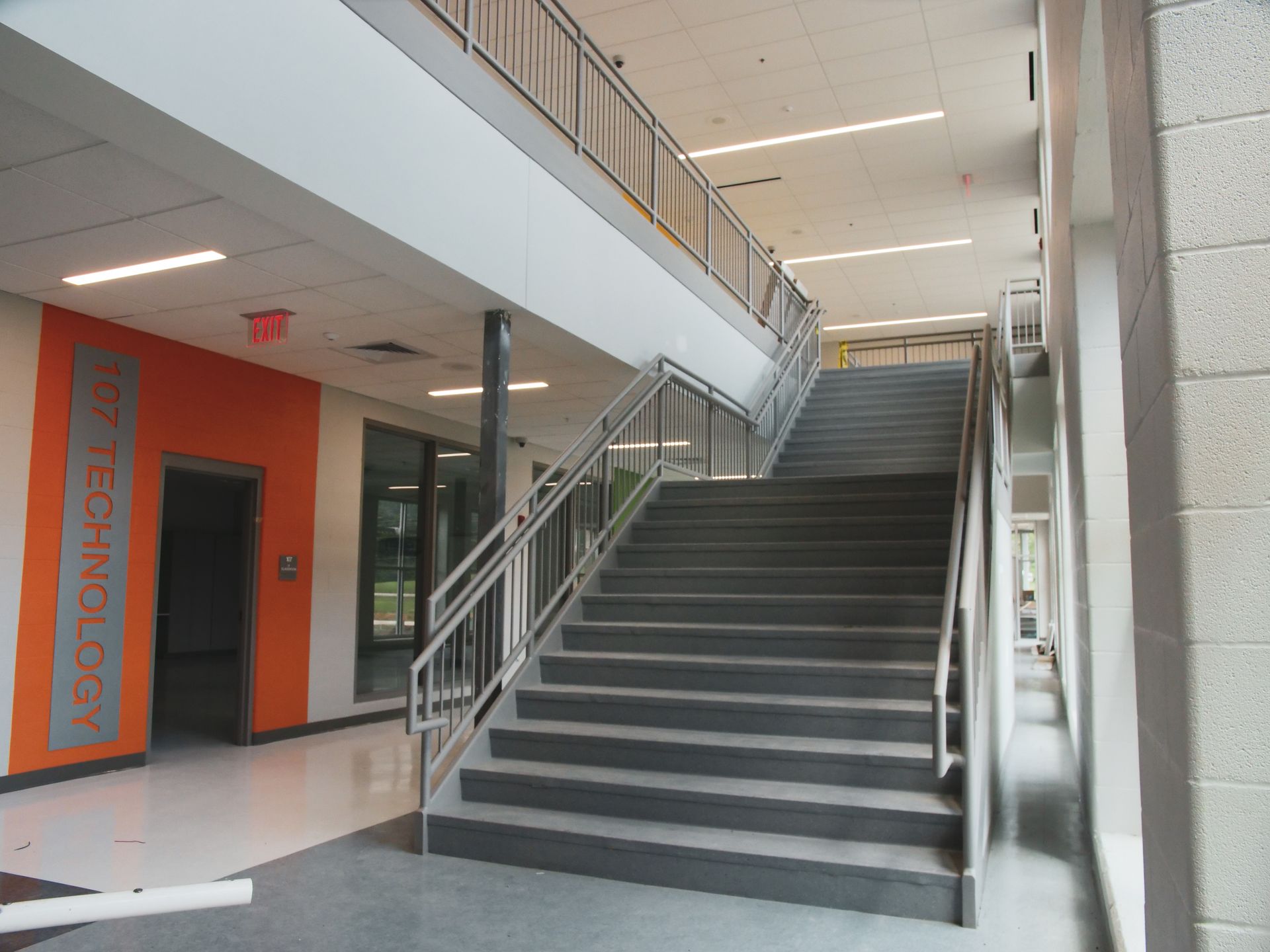 A staircase in a building with the word technology on the wall