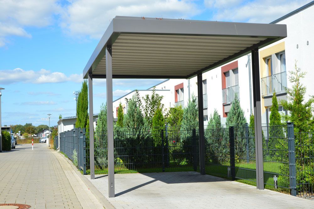 New Metal Carport With Greened Roof In Front Of A Multi Family Residential Building — Custom Builder in Alstonville, NSW