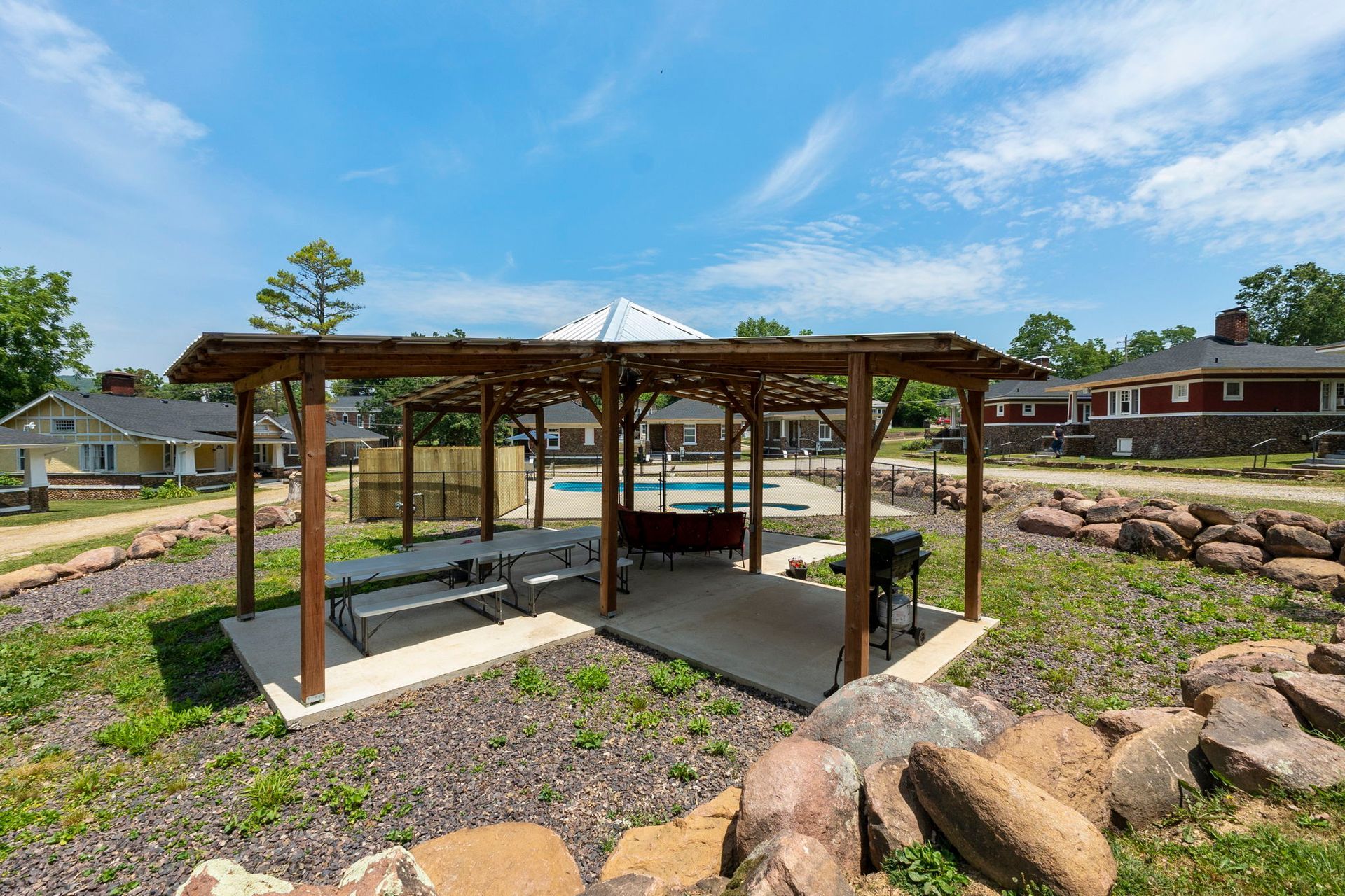 There is a gazebo with a table and chairs underneath it.