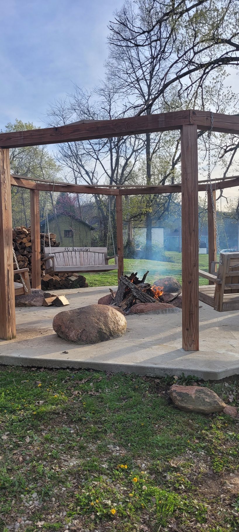 There is a fire pit in the middle of the yard.