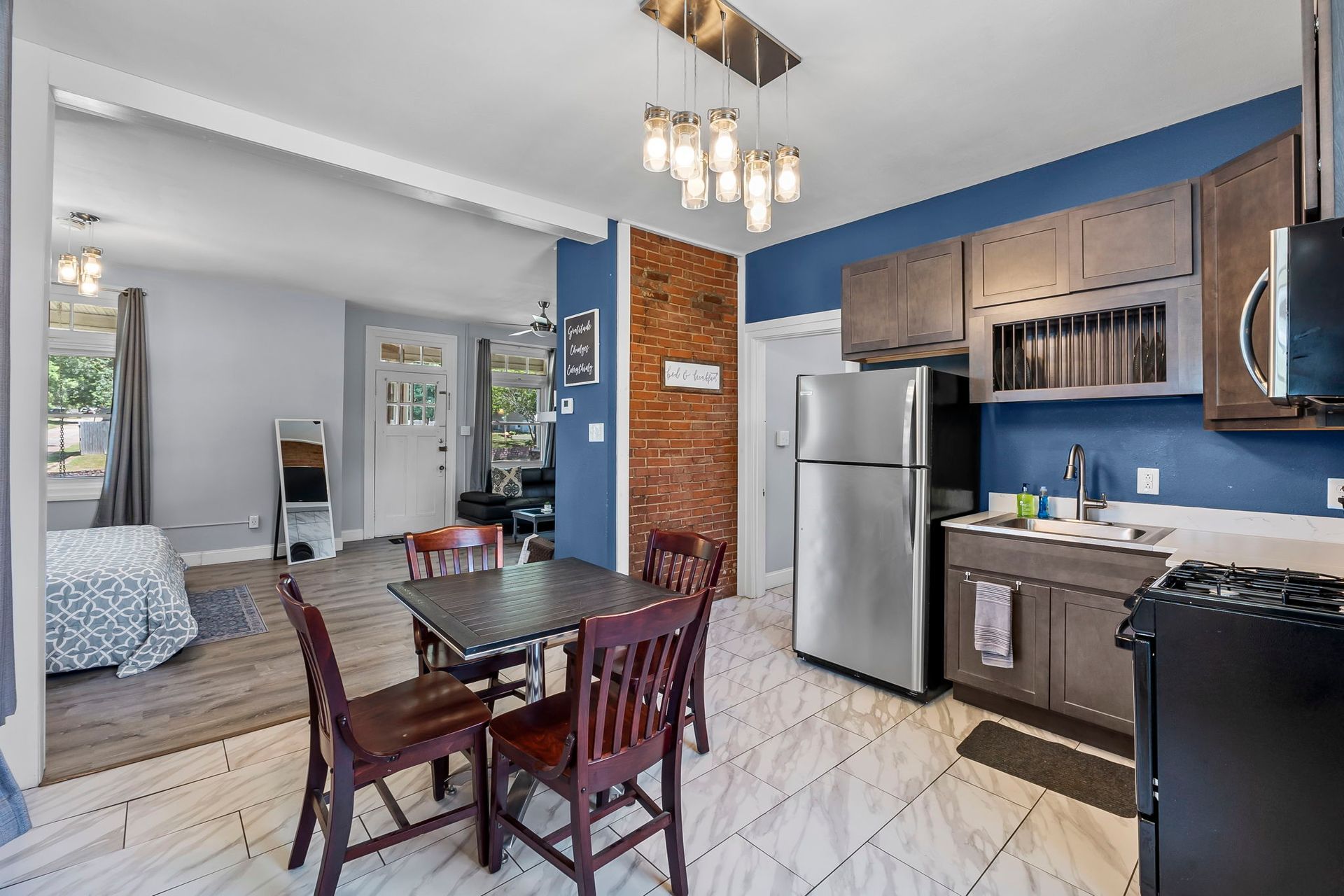 A kitchen with a table and chairs and a refrigerator