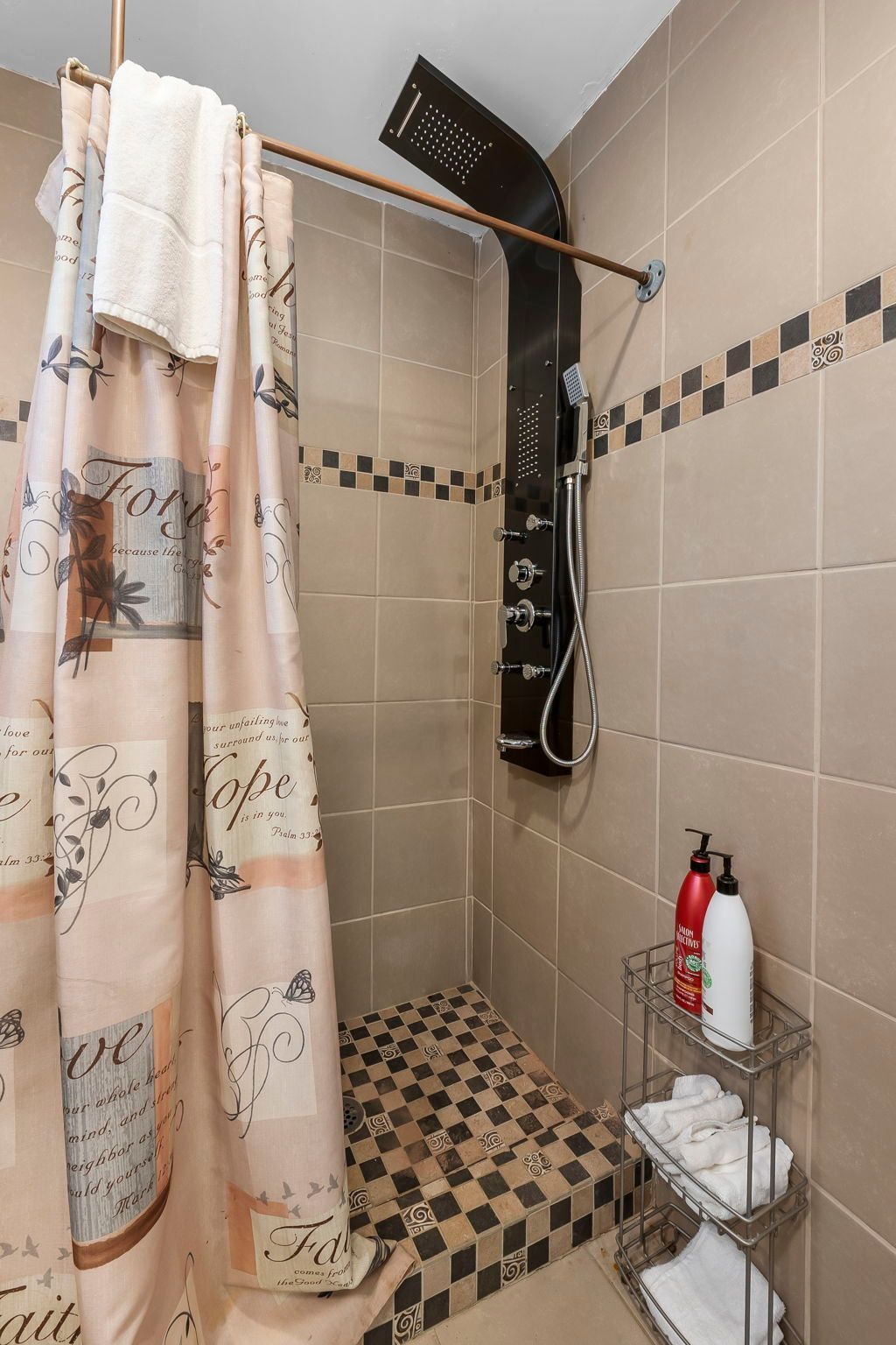 a bathroom with a shower curtain and a shower head .