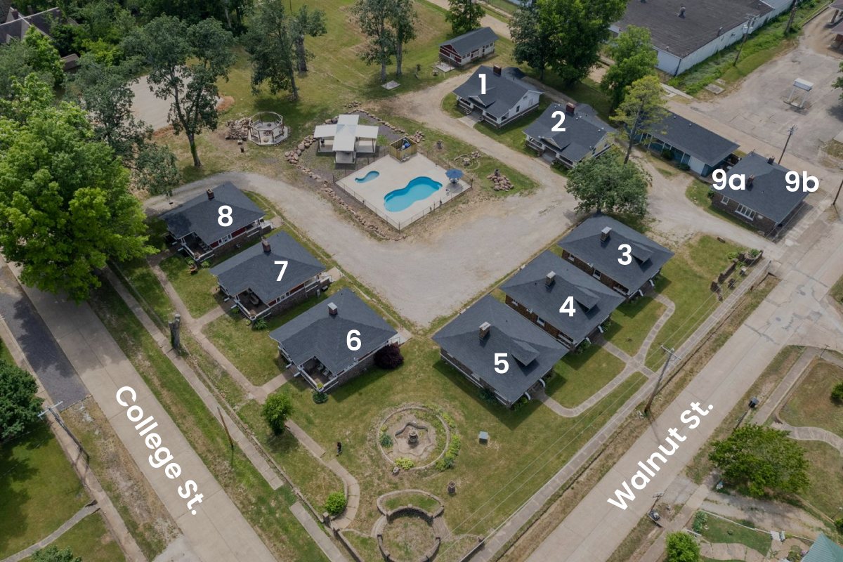 An aerial view of a residential area with houses and a pool