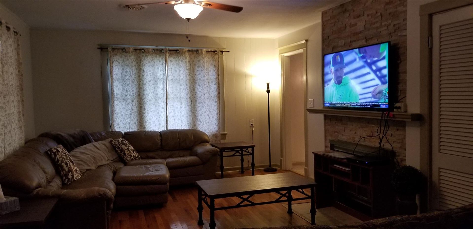 A living room filled with furniture and a flat screen tv.