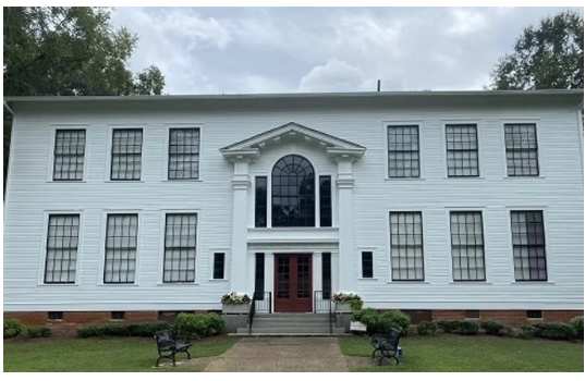 Hearn Academy, a white 2 story building with 12 windows 