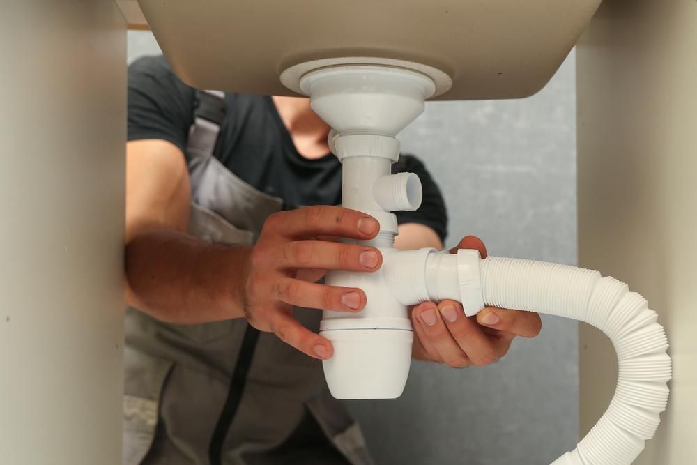 A Man is Fixing a Sink Pipe Under a Sink — Sidney & Richardson In  Ballina, NSW