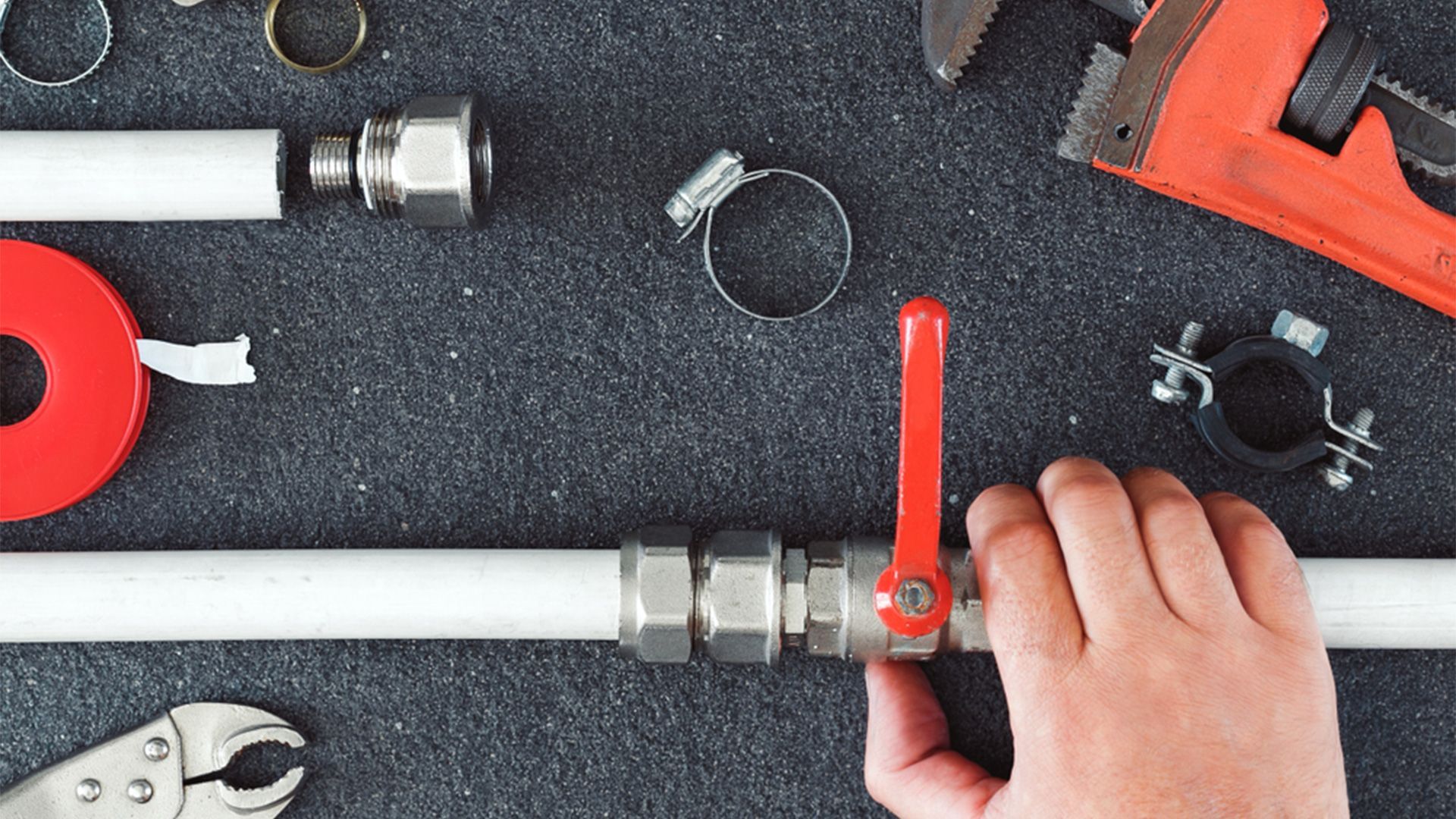 A Person is Fixing a Pipe With a Red Valve — Sidney & Richardson In  Ballina, NSW