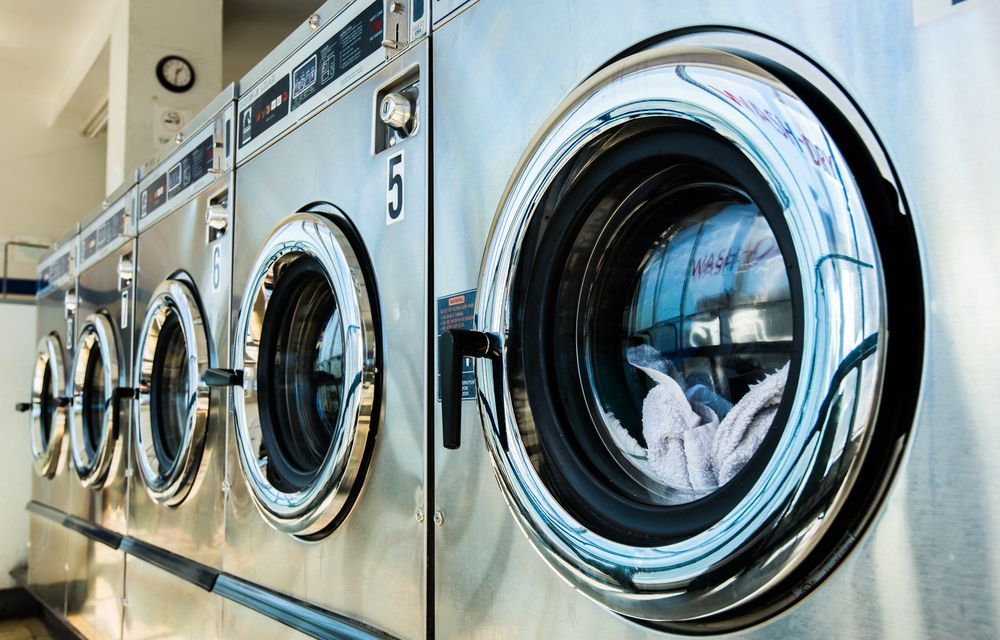 Row of Industrial Stainless Steel Washing Machines — Flynns Beach Service Laundry in Lake Cathie, NSW