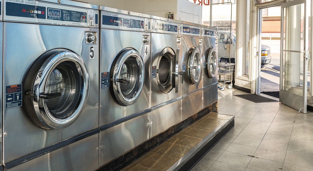 Row of Stainless Steel Commercial Laundry Machines — Flynns Beach Service Laundry in Laurieton, NSW