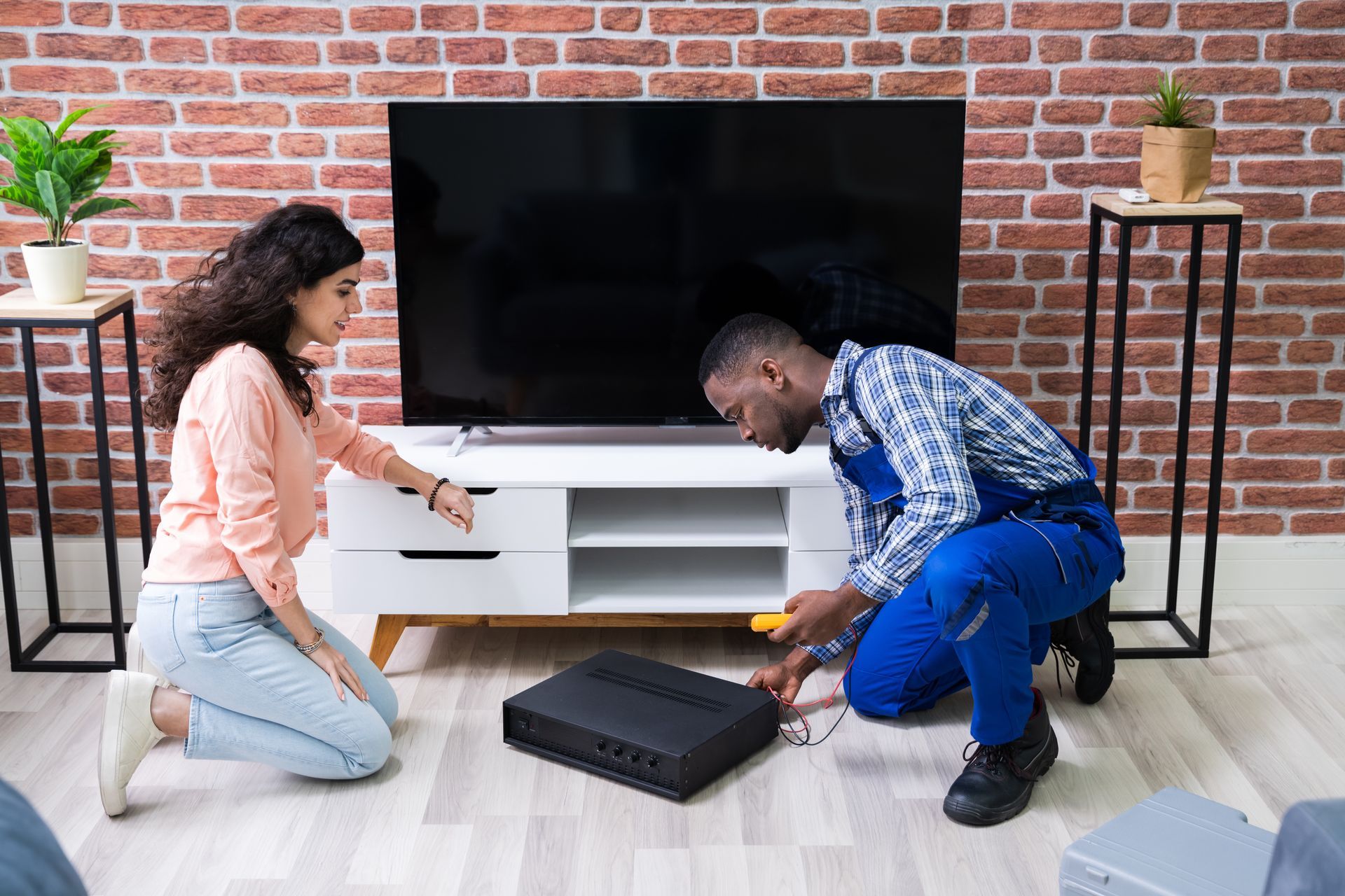 A technician installing a home theater system